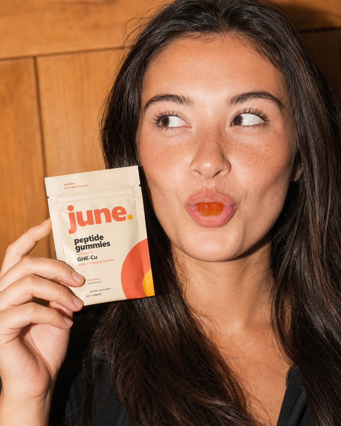 Woman enjoying a June GHK-Cu peptide gummy